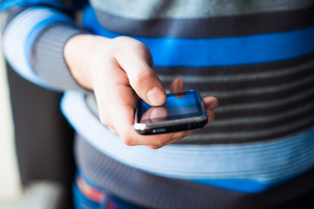 Close up of a man using mobile smart phoneの写真素材