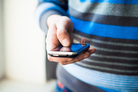 Close up of a man using mobile smart phoneの写真素材