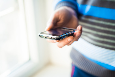 Close up of a man using mobile smart phoneの写真素材