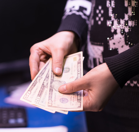 Money in the hand (Hand with money, Hand holding Banknotes)の写真素材