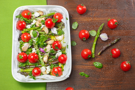 Asparagus and Cherry Tomatoes getting ready for the ovenの写真素材