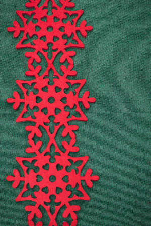 Christmas background. Christmas card with red snowflakes against green background.の写真素材