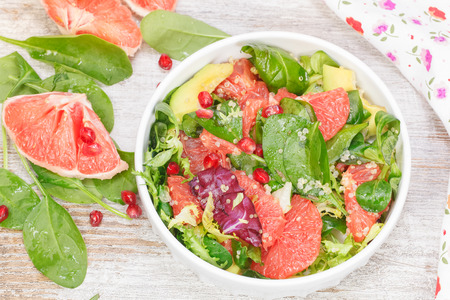 Salad. Fresh salad with grapefruit, avocado and pomegranate seeds. High angle viewの写真素材