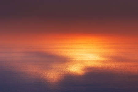 Sunlight reflecting off water. Scenic view of sunset over seaの写真素材