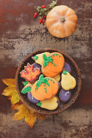 Thanksgiving cookies  and squash  on rustic table.  Thanksgiving cookies in the shape of pumpkin, pear, plum and leaves. Fall decorated cookiesの写真素材