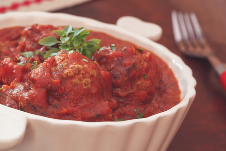 Meatballs in bolognese sauce with basil. Macro, selective focus, vintage toned imageの写真素材