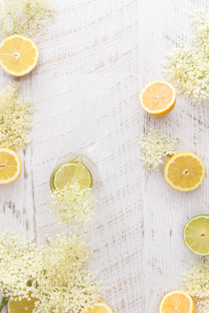 Elderflower cordial and ingredients.  Homemade elder flower cordial with lemons and elderflowers  on a rustic table. Top view with copyspace in the middleの写真素材