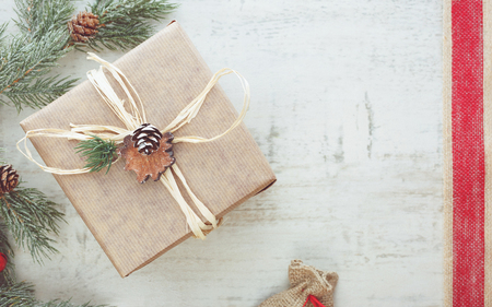 Christmas gift wrapped in brown paper.  Vintage toned image, top view, blank spaceの写真素材