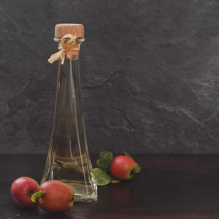 Apple vinegar. Bottle of apple organic vinegar on rustic backgroundの写真素材