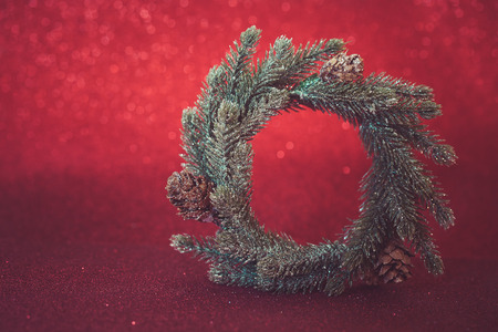 Christmas card. Red holiday glitter background with wreath. Selective focus,blank spaceの写真素材