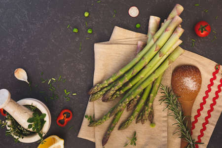 Fresh asparagus and ingredients,dark surface, copy space, top viewの写真素材