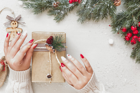 Woman Wrapping Christmas Gifts On Festive White Table. Top View, Blank Spaceの写真素材