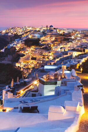 Unique view for the sunset over Oia, Santorini, a small, beautiful village on the edge of the caldera, Greeceの写真素材