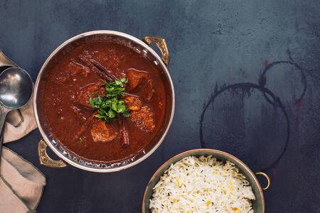 Kashmiri Lamb Rogan Josh. Slow cooked lamb curry served with pulao rice and garnished with coriander. Top view, blank spaceの写真素材