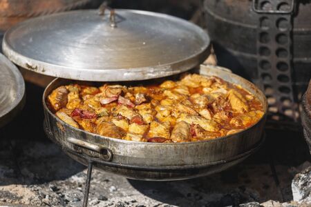 Stuffed cabbage rolls in clay pot on simmering ashes, traditional Serbian dish consisting of sour...