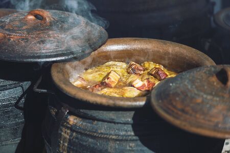 Traditional Serbian wedding cabbage boiled in earth cauldrons on simmering ashes,outdoors, ...