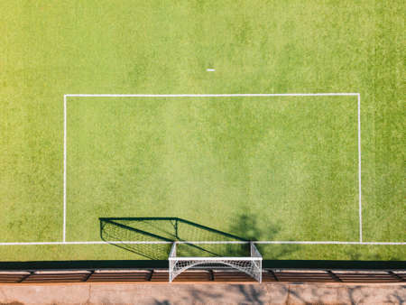 Soccer Ground Detail. Outdoor sport ground with green surface for playing football  or soccer  in urban area, detail, drone viewの写真素材