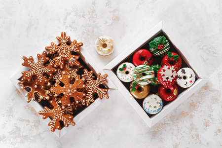Christmas Cookie Boxes. Cardboard boxes with donuts and gingerbread as a gift. Top view, blank spaceの写真素材