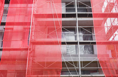 Construction Scaffolding Wrap Detail. Newly erected building still in scaffolding.の写真素材
