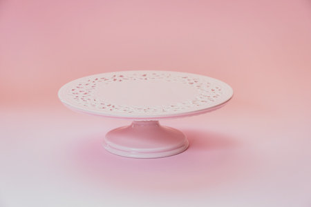 Empty  ceramic pink cake stand on a pastel pink table with copy space, selective focusの写真素材