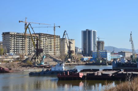 This picture shows a town port with cranesの写真素材