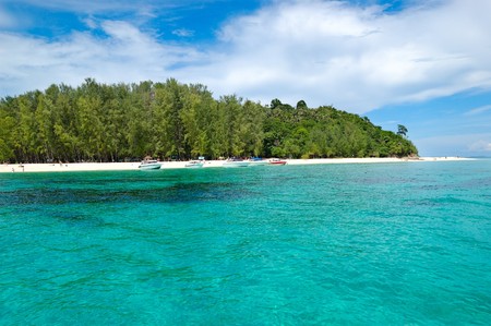 Beach with motor boats on turquoise water of Indian Ocean, Phi Phi island, Thailandの写真素材