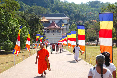 KANDY - OCTOBER 17: Monk and people are near the Temple of the Lord Buddha Tooth Relic. October 17, 2011 in Kandy, Sri Lanka. In the Temple is located a Golden Sarcophagus with the Buddha Tooth Relic. のeditorial素材
