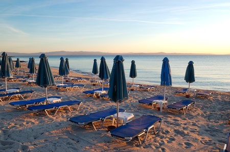 Sunbeds on a beach during sunrise, Halkidiki, Greeceの写真素材