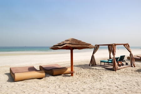 Beach with hut and sunbeds of the luxury hotel, Ajman, UAEのeditorial素材