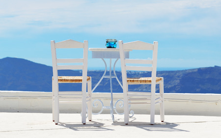 The chairs on the top of house, Santorini island, Greeceの写真素材