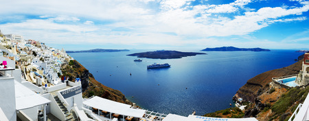 FIRA, GREECE - MAY 17: The view on Fira town and tourists enjoying their vacation on May 17, 2014 in Fira, Greece. Up to 16 mln tourists is expected to visit Greece in year 2014.のeditorial素材