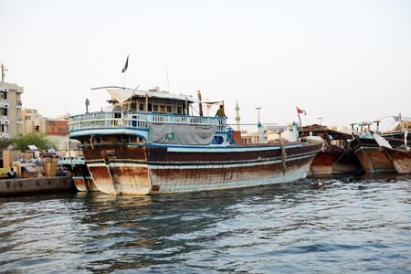 DUBAI, UAE - SEPTEMBER 10: The traditional cargo ship in Dubai Creek on September 10, 2013 in Dubai, United Arab Emirates. In the city of artificial channel length of 3 kilometers along the Persian Gulf.のeditorial素材