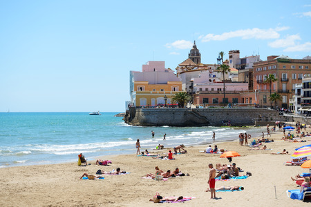 SITGES, SPAIN - MAY 23: The tourists enjoiying their vacation on the beach on May 23, 2015 in Sitges, Spain. Up to 60 mln tourists is expected to visit Spain in year 2015.のeditorial素材