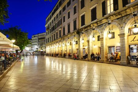 KERKYRA, GREEES - MAY 14: The tourists are in cafes in Liston during sunset on May 14, 2016 in Kerkyra, Greece. Up to 16 mln tourists is expected to visit Greece in year 2016.のeditorial素材
