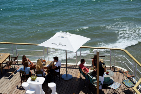 SITGES, SPAIN - MAY 23: The tourists enjoiying their vacation in outdoor restaurant on May 23, 2015...