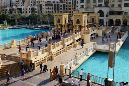 DUBAI, UAE - NOVEMBER 19: The view on Souk Al Bahar and tourists are near Dubai Mall . It is the worlds largest shopping mall.  It is located in Burj Khalifa complex and has 1200 shops inside on November 19, 2017のeditorial素材
