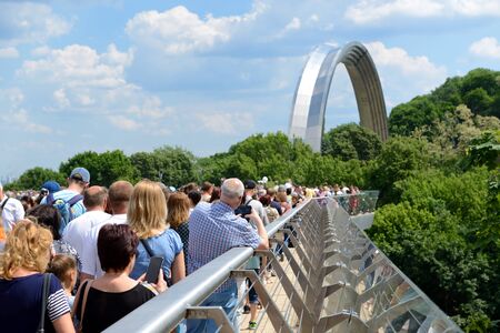 KYIV, UKRAINE - MAY 26: The group of people is on new pedestrian bridge which connect the People's Friendship Arch and Volodimir the Great monument on May 26, 2019 in Kyiv, Ukraine. The bridge have been opened on May 25 by Mayor of Kyiv Vitaliy Klichko.のeditorial素材