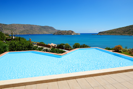 Swimming pool at luxury hotel with a view on Spinalonga Island, Crete, Greeceのeditorial素材
