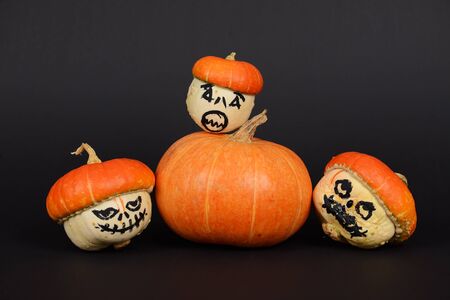 The orange pumpkins painted for Halloween on black backgroundの写真素材
