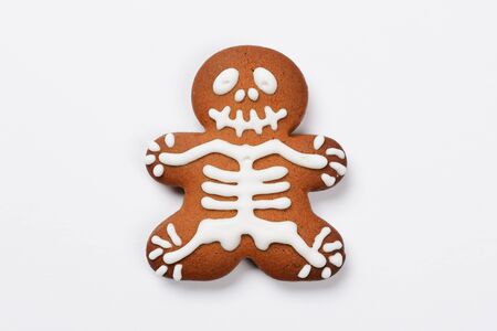The hand-made eatable gingerbread Halloween sceleton on white backgroundの写真素材