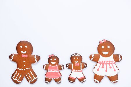 The hand-made eatable gingerbread family on white backgroundの写真素材