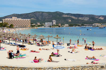 MALLORCA, SPAIN - MAY 29: The tourists enjoiying their vacation on the beach on May 29, 2015 in Mallorca, Spain. Up to 60 mln tourists is expected to visit Spain in year 2015.のeditorial素材