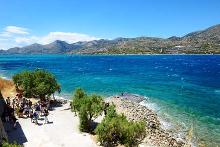 SPINALONGA, GREECE - MAY 14: The tourists are on Spinalonga island and view on Crete island on May...