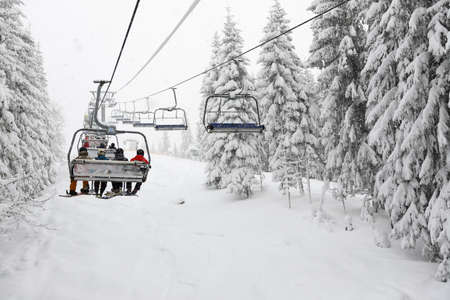 BUKOVEL, UKRAINE - DECEMBER 25:  The skiers are on a cableway in Bukovel ski resort. It is the largest ski resort in Ukraine with 68 km of pistes on December 25, 2018 in Bukovel, Ukraineのeditorial素材