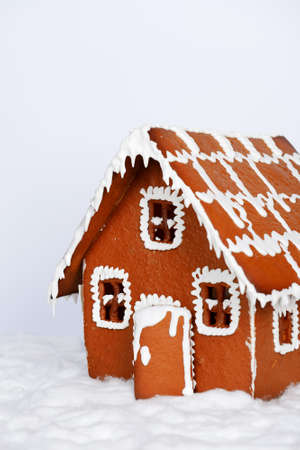 The hand-made eatable gingerbread house and snow decorationの写真素材