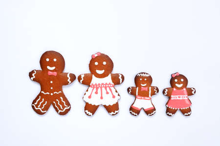 The hand-made eatable gingerbread house, little men on white backgroundの写真素材