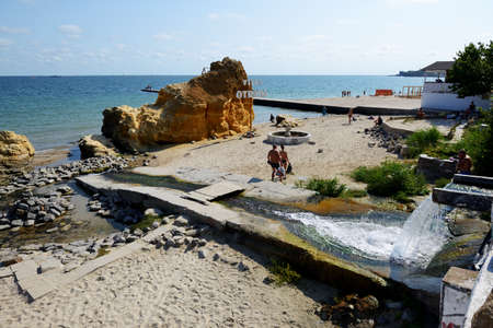 ODESA, UKRAINE - SEPTEMBER 25: The people taking sunbath on a beach on September 25, 2020 in Odesa, Ukraine.のeditorial素材