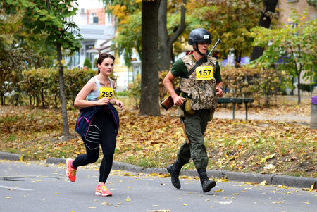 BILA TSERKVA, UKRAINE - OCTOBER 6: The running participant of Bila Tserkva Marathon is in accoutrement of Ukrainian Army which weight more then 20 kg on October 6, 2019 in Bila Tserkva, Ukraine.のeditorial素材