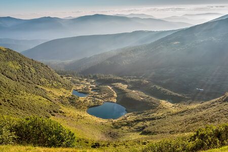 Summer landscape in mountains and the dark blue sky with cloudsの写真素材
