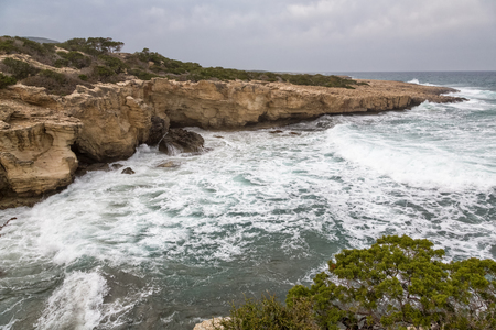 Mediterranean Sea waves breaking rocky coastline of Cyprus islandの写真素材
